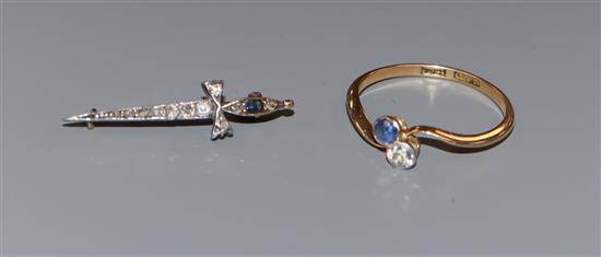 An early 20th century 18ct, two stone sapphire and diamond crossover ring and a similar sapphire and diamond set dagger brooch